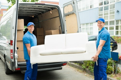Removal van team sorting recyclable household items for reuse and recovery