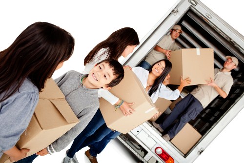 Office relocation team preparing business furniture for a local move in Removalvan