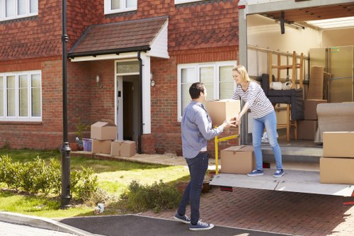 Business relocation scene showing office furniture and packed cartons ready for delivery