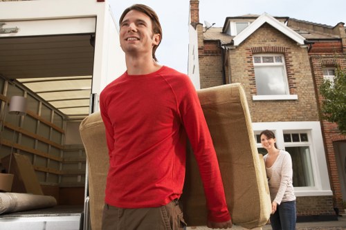 Moving team handling boxes and furniture in a residential area